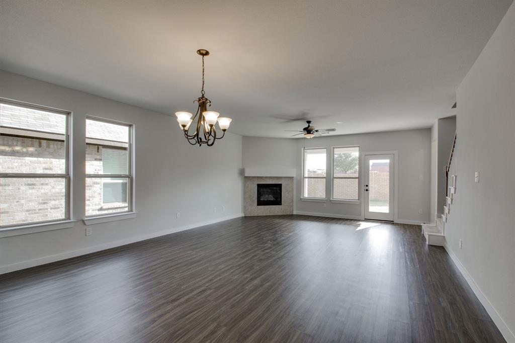 7612 Spring Drive Watauga, TX 76148 - Photo 14 of 40 an empty room with wooden floor and windows