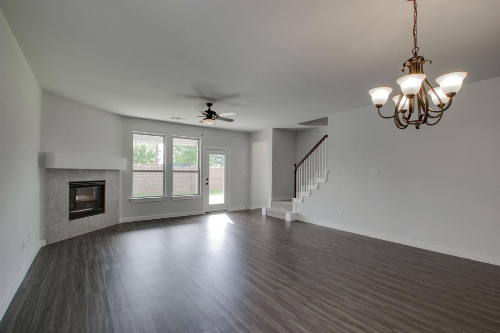 7612 Spring Drive Watauga, TX 76148 - Photo 15 of 40 a view of an empty room with wooden floor and a window