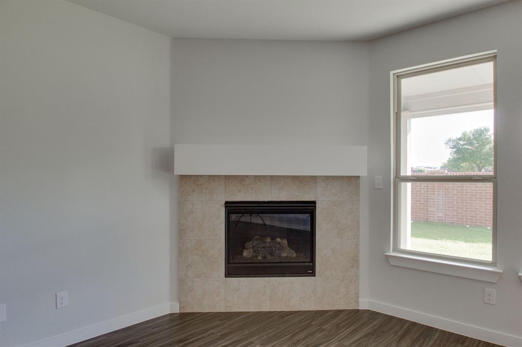 7612 Spring Drive Watauga, TX 76148 - Photo 16 of 40 a living room with a fireplace and a window