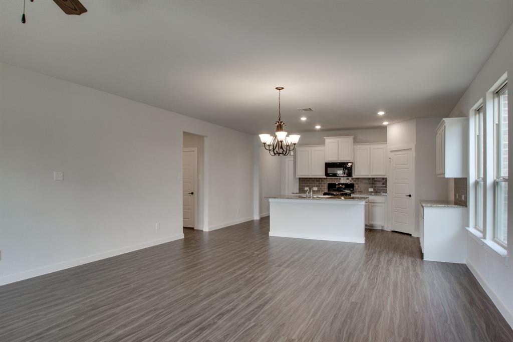 7612 Spring Drive Watauga, TX 76148 - Photo 17 of 40 a large kitchen with a wooden floor and stainless steel appliances