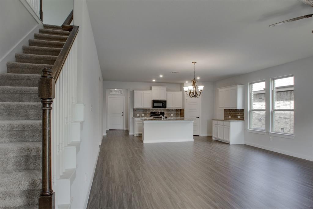 7612 Spring Drive Watauga, TX 76148 - Photo 18 of 40 a view of a kitchen with cabinets and wooden floor