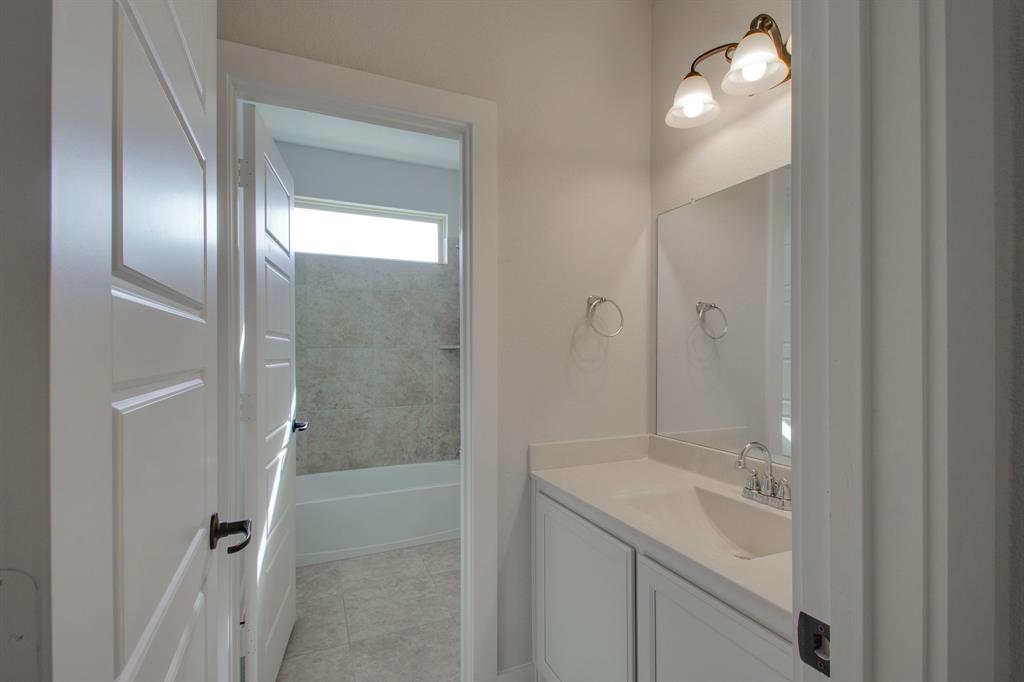 7612 Spring Drive Watauga, TX 76148 - Photo 23 of 40 a bathroom with a bathtub and a shower