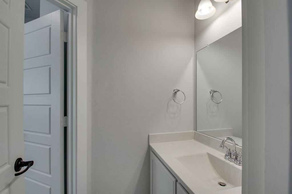 7612 Spring Drive Watauga, TX 76148 - Photo 25 of 40 a bathroom with a sink a toilet and shower