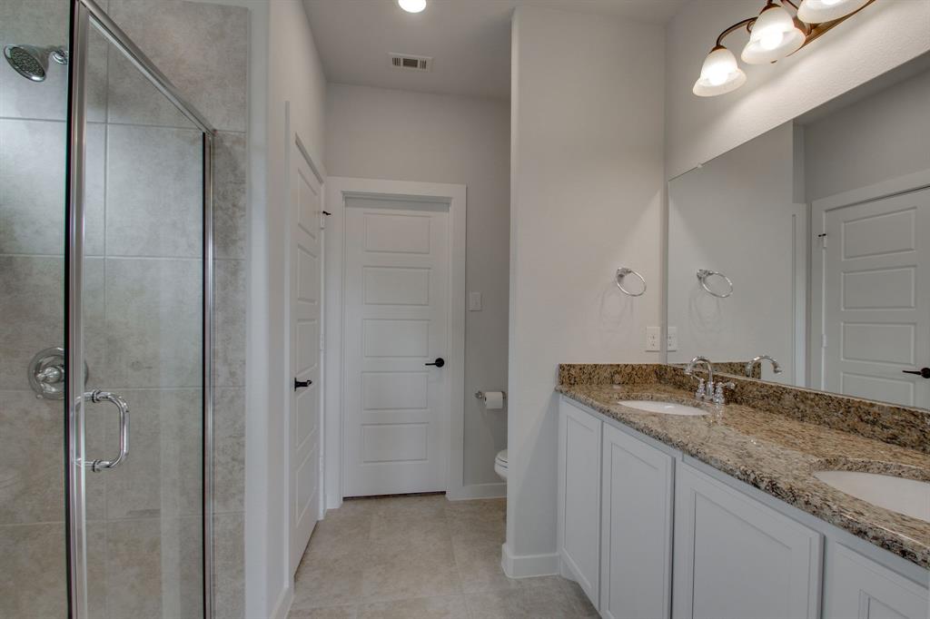 7612 Spring Drive Watauga, TX 76148 - Photo 31 of 40 a bathroom with a granite countertop sink and a mirror