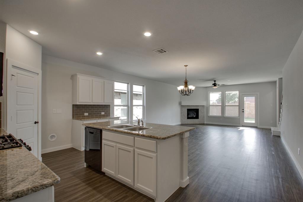 7612 Spring Drive Watauga, TX 76148 - Photo 10 of 40 a kitchen with a sink stove and cabinets