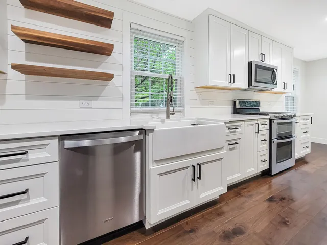 a kitchen with white cabinets and a stainless steel appliances