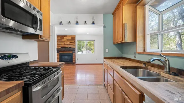 a kitchen with stainless steel appliances granite countertop a sink and a stove