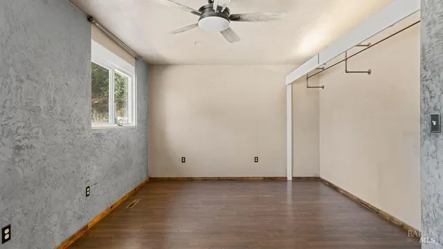 a view of room with window and hardwood floor