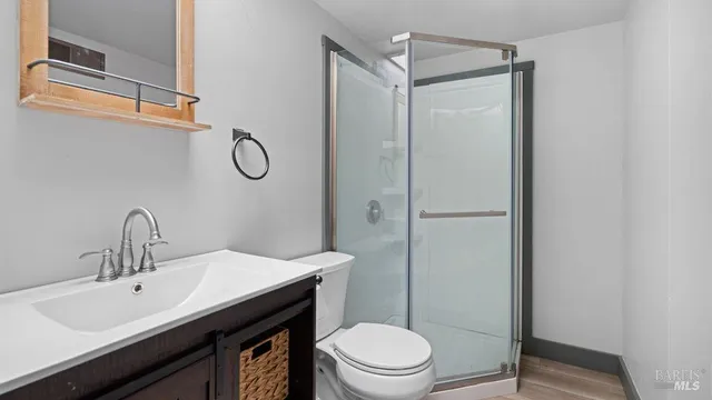 a bathroom with a granite countertop sink toilet and shower