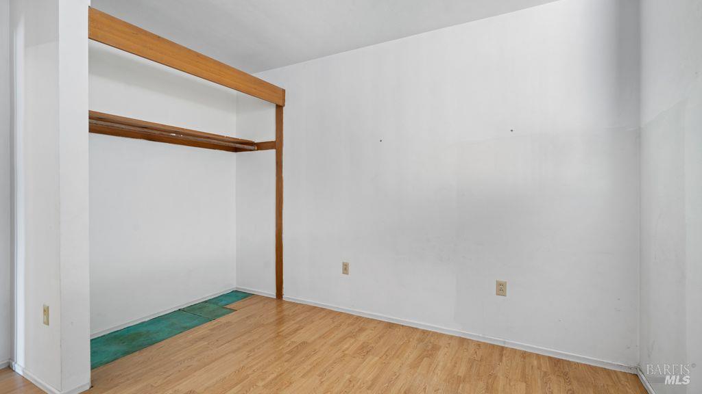40 El Rancho Drive Cloverdale, CA 95425 - Photo 26 of 44 a view of an empty room with wooden floor and a window