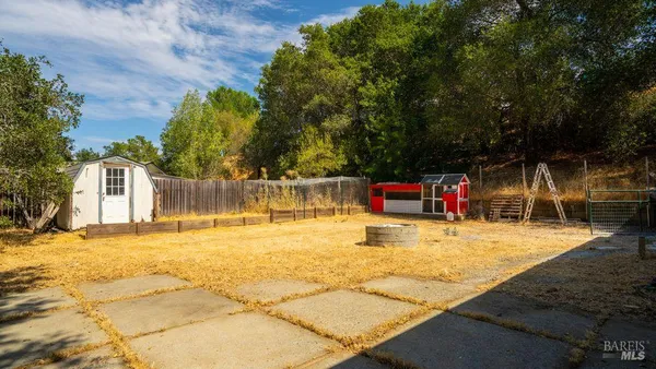 a backyard of a house with yard and outdoor seating