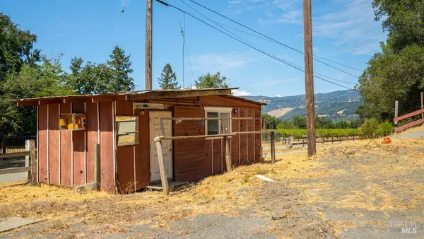 a view of a backyard with wooden fence