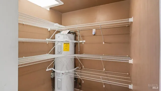 a view of utility room with racks on the wall