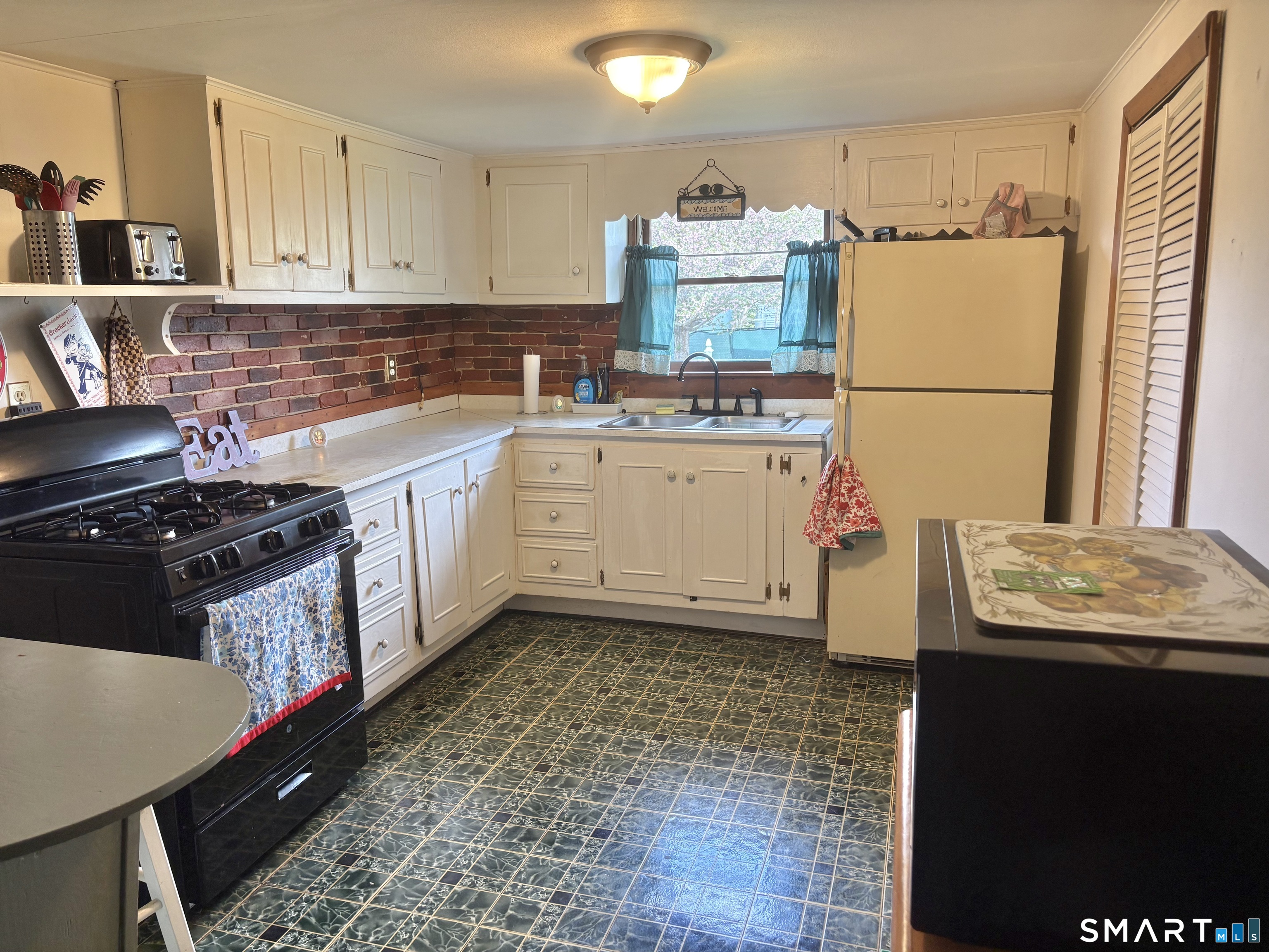 21 Friendship Street Norwich, CT 06360 - Photo 6 of 17 a kitchen with a sink stove and refrigerator