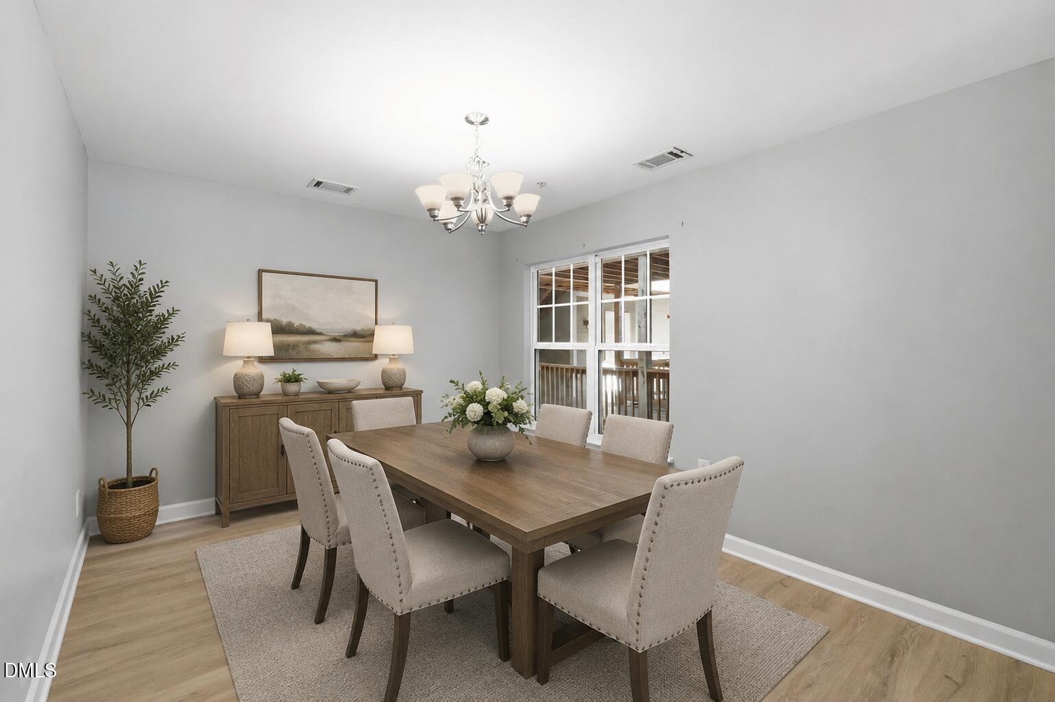 929 Morreene Road, Unit A23 Durham, NC 27705 - Photo 9 of 41 a view of a dining room with furniture and chandelier