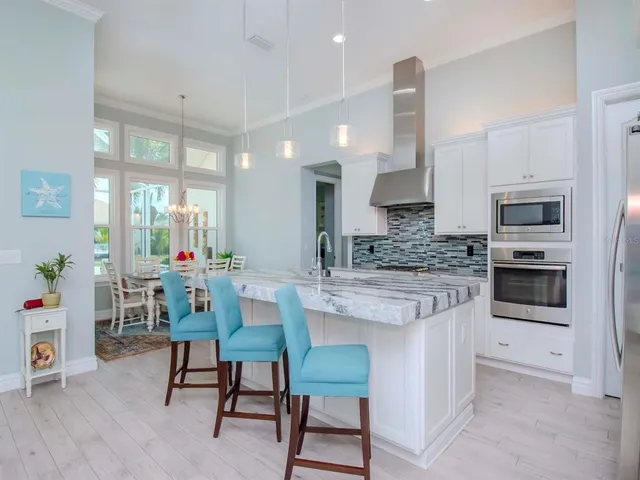 a kitchen with sink stove and microwave