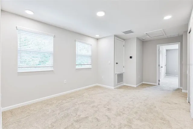 an empty room with windows and closet