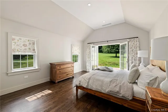 a bedroom with a bed and large window