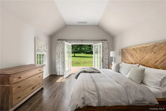 a spacious bedroom with a bed and a window