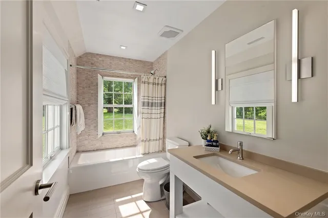 a bedroom with a bed a window and chair