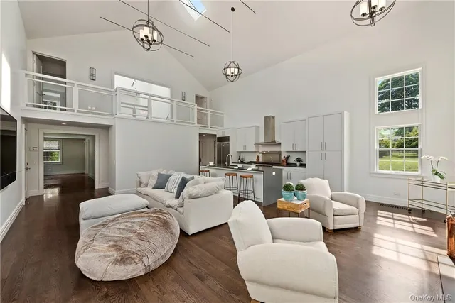 a living room with furniture a fireplace and wooden floor