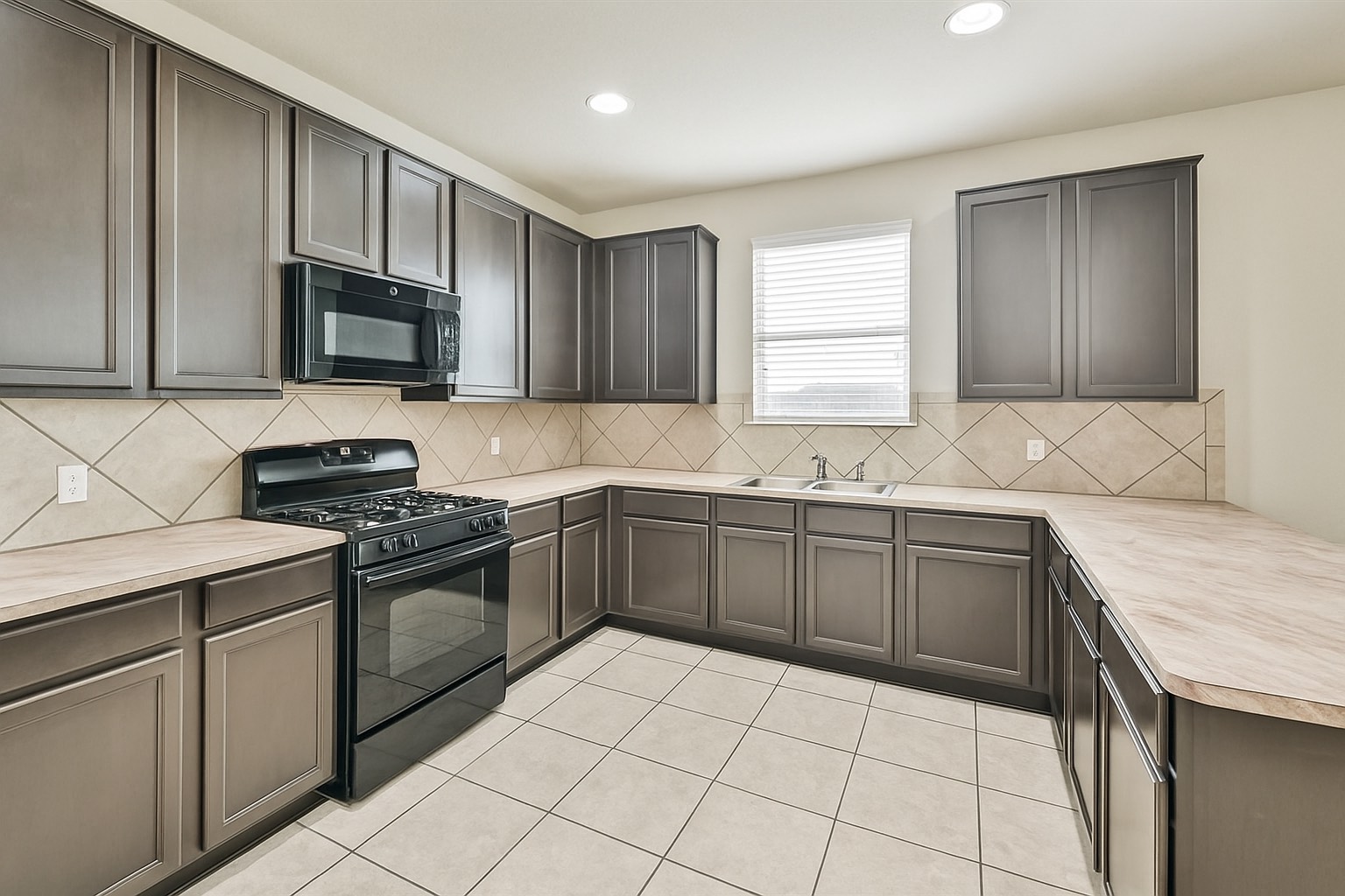 10930 Chestnut Path Way Tomball, TX 77375 - Photo 6 of 18 a kitchen with granite countertop a sink a stove top oven and cabinetry