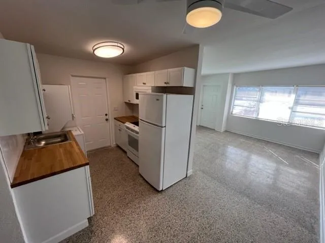 a kitchen with refrigerator and window