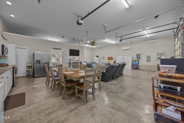 a kitchen with stainless steel appliances granite countertop a sink a microwave a stove a table and chairs