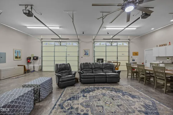 a large kitchen with kitchen island a large window a sink and stainless steel appliances