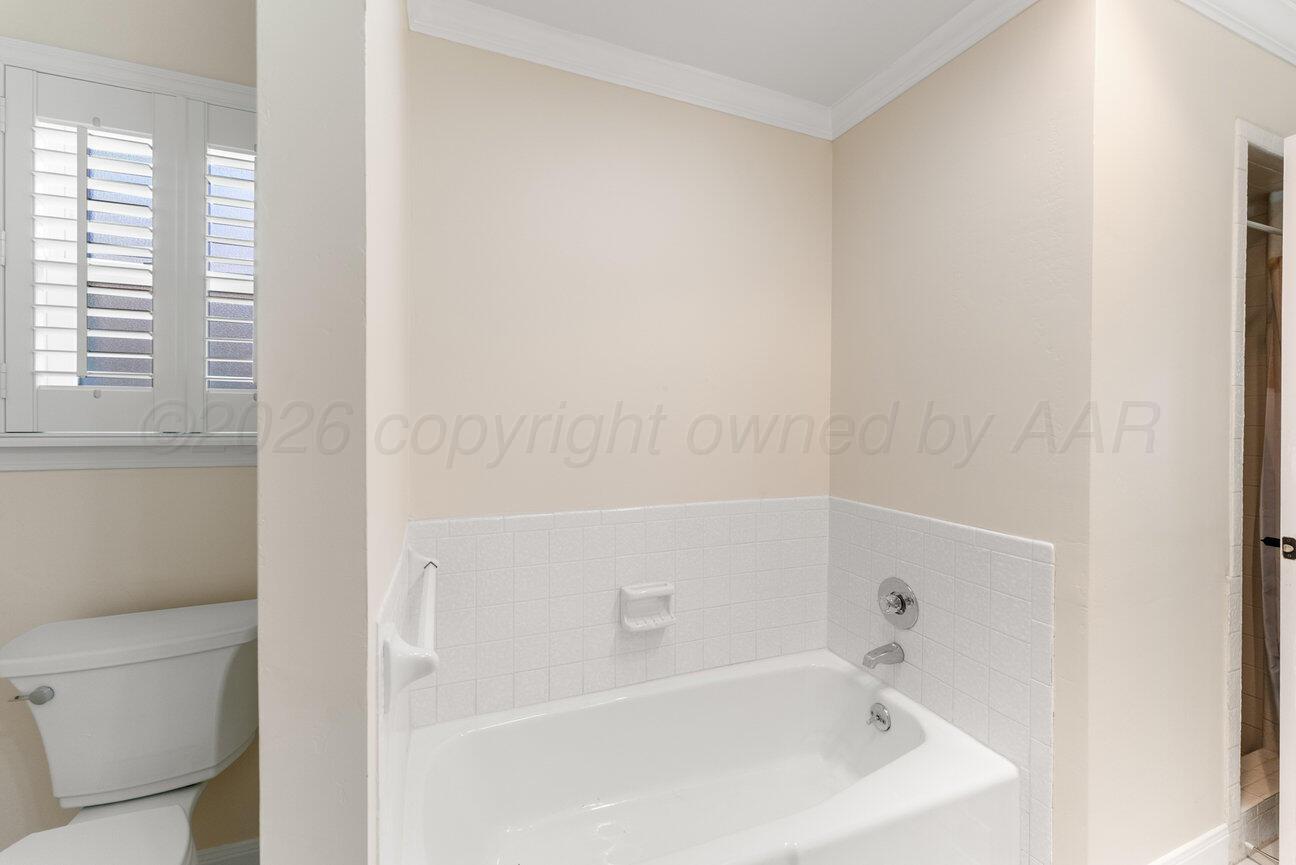 7204 Southwest 39th Avenue Amarillo, TX 79109 - Photo 33 of 51 a bathroom with a bathtub and a toilet