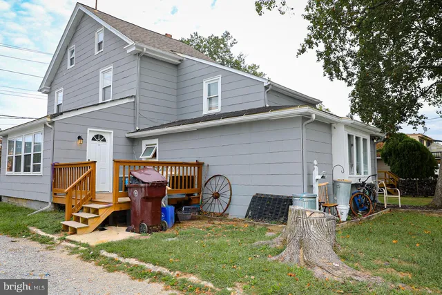 a front view of a house with a yard and green space