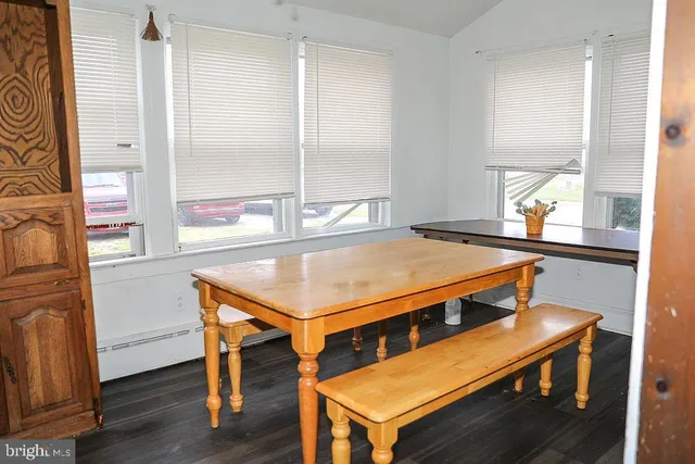 a kitchen with a wooden floor and white appliances