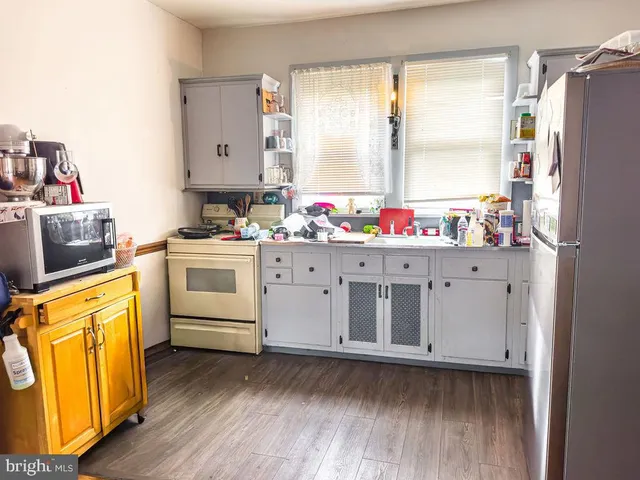 a kitchen with stainless steel appliances a refrigerator and a stove top oven