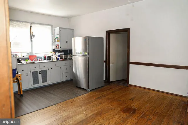 a bedroom with furniture and a wooden floor