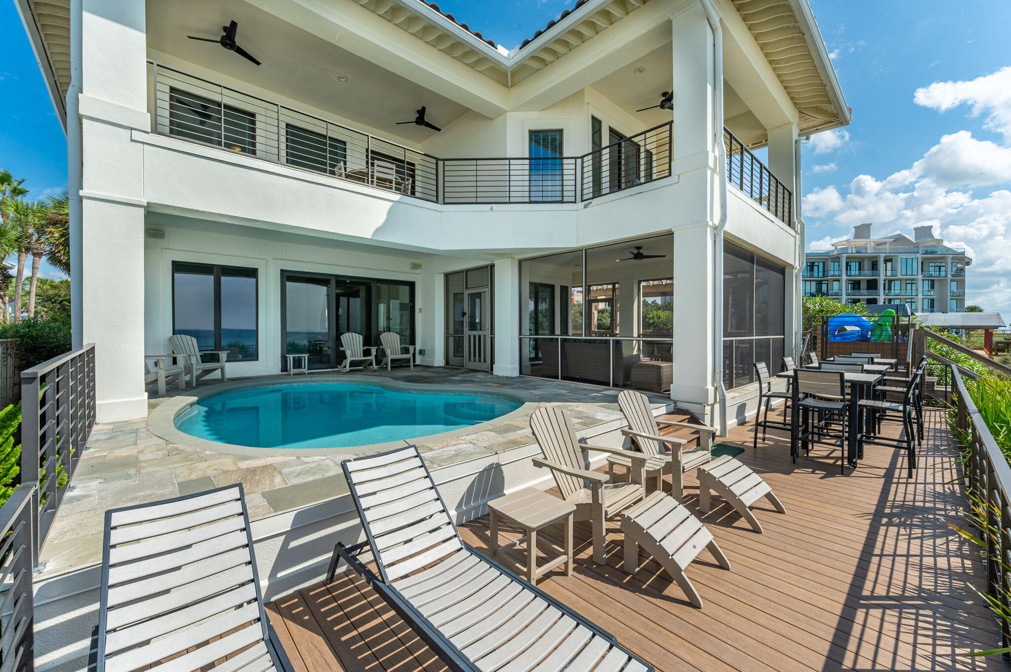 4525 West County Highway 30A Santa Rosa Beach, FL 32459 - Photo 3 of 118 a view of a patio with couches table and chairs and potted plants