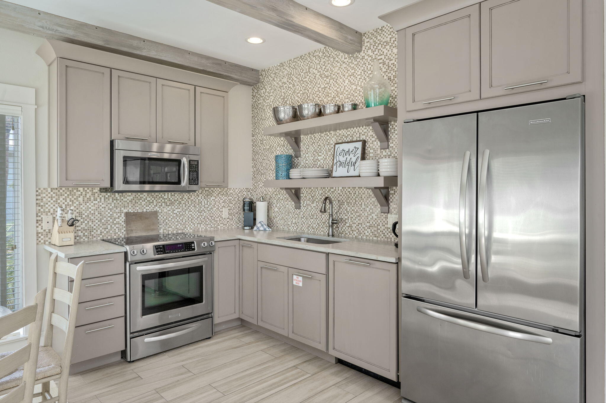 4525 West County Highway 30A Santa Rosa Beach, FL 32459 - Photo 91 of 118 a kitchen with stainless steel appliances granite countertop a refrigerator a stove and a sink with wooden floor