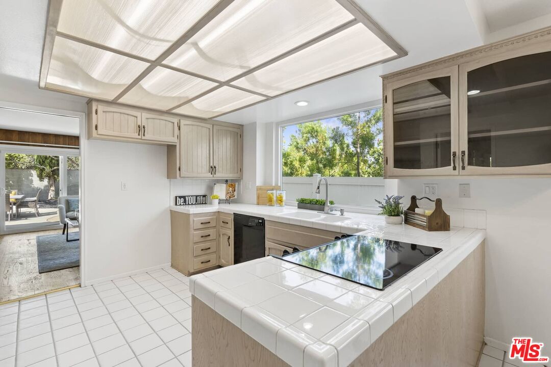 26741 Nokomis Road Rancho Palos Verdes, CA 90275 - Photo 12 of 28 a kitchen with a sink a stove top oven and cabinetry