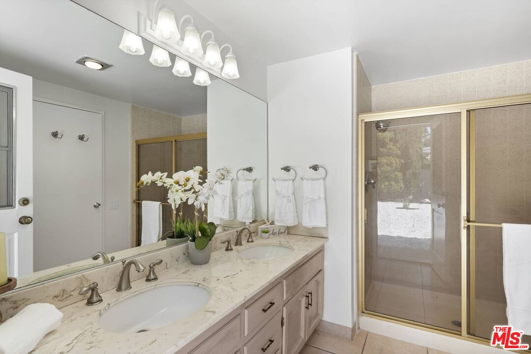 26741 Nokomis Road Rancho Palos Verdes, CA 90275 - Photo 21 of 28 a bathroom with a granite countertop double vanity sink a shower and a mirror