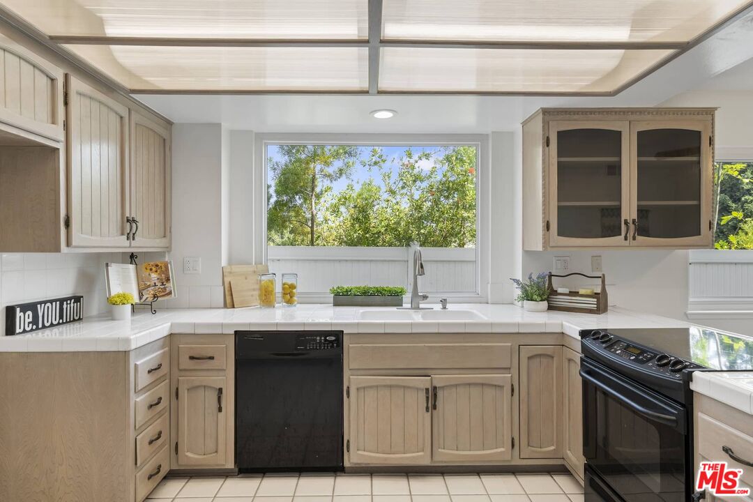26741 Nokomis Road Rancho Palos Verdes, CA 90275 - Photo 7 of 28 a kitchen with stainless steel appliances granite countertop a sink stove and cabinets