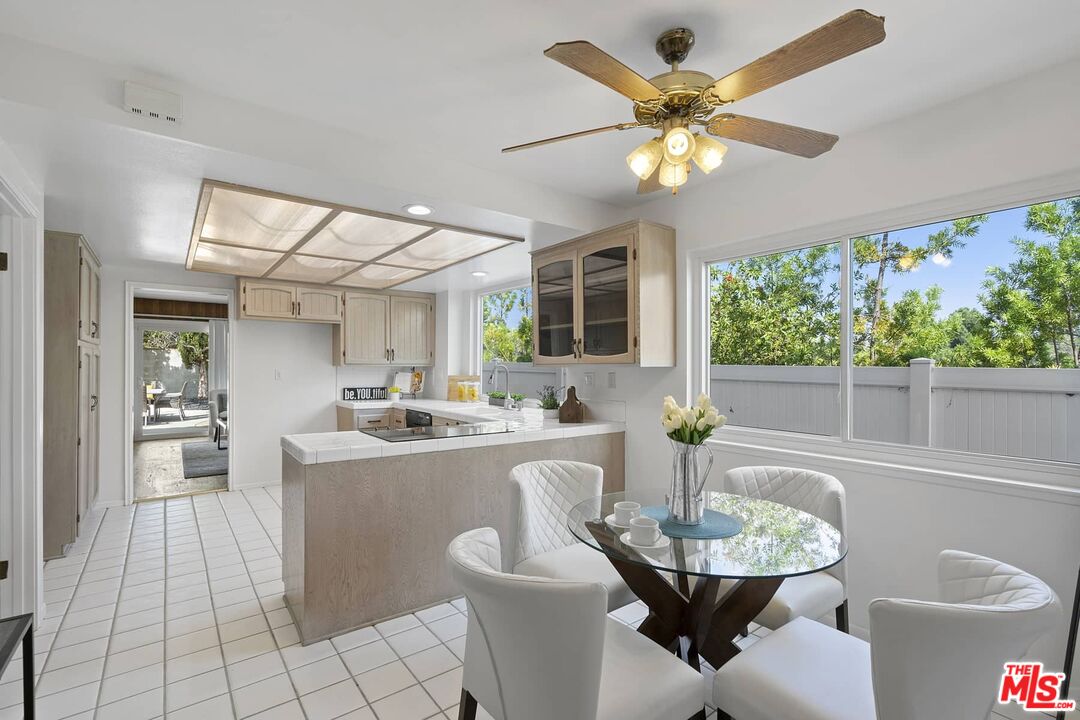 26741 Nokomis Road Rancho Palos Verdes, CA 90275 - Photo 10 of 28 a dining room with furniture a large window and a chandelier