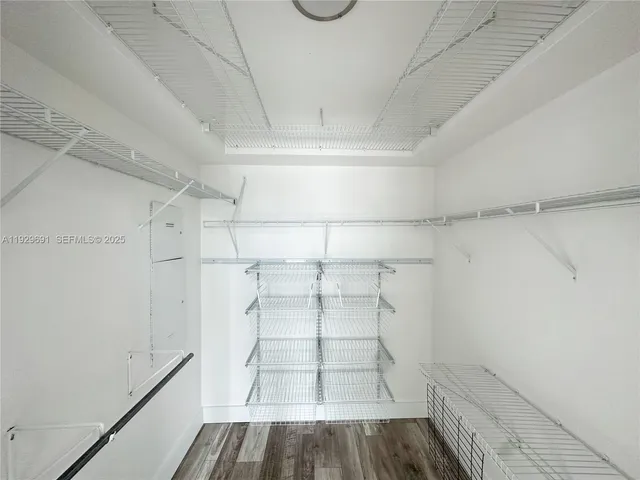 a view of walk in closet with empty racks