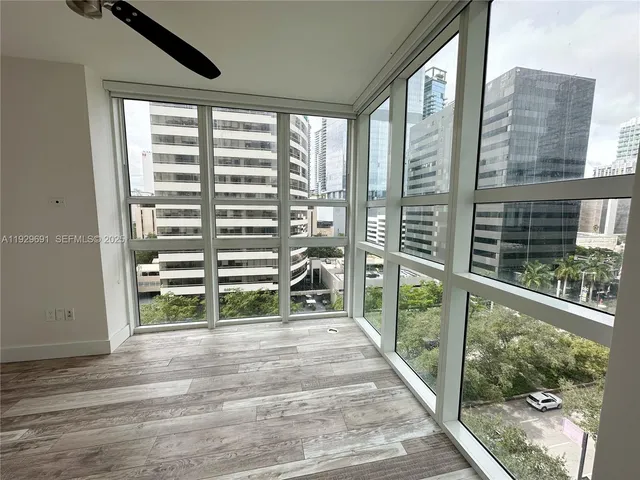 a view of a balcony with floor to ceiling windows