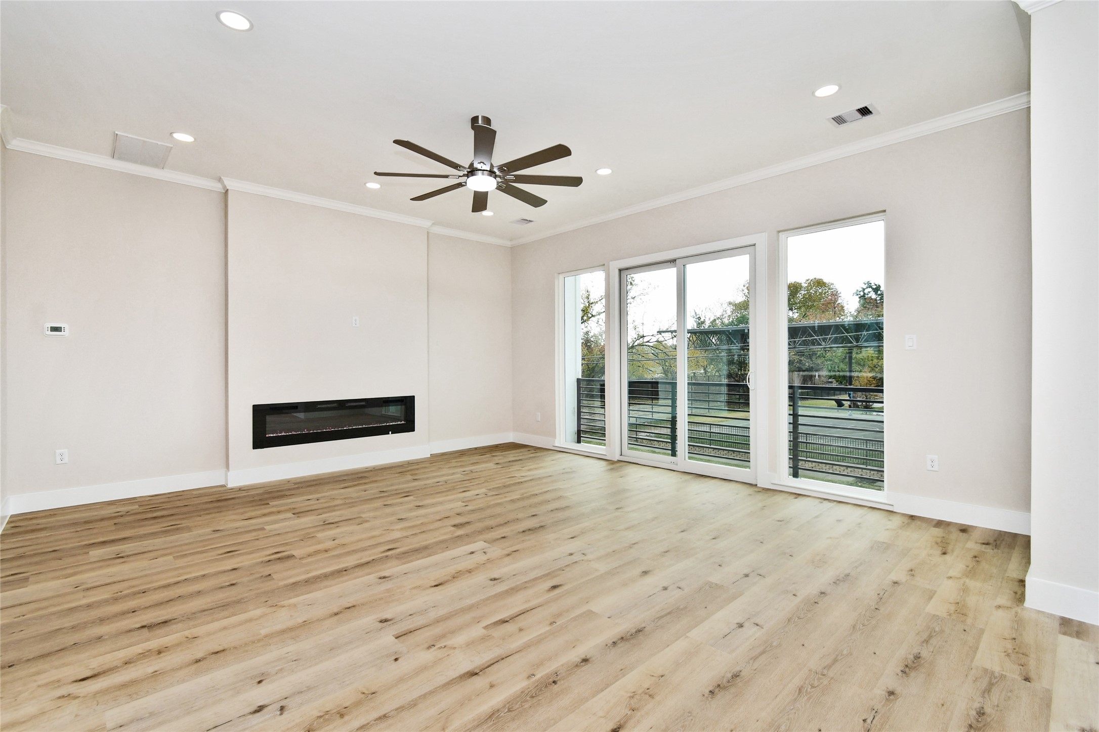 3231 Tuam Street Houston, TX 77004 - Photo 12 of 49 a view of an empty room with a window and wooden floor
