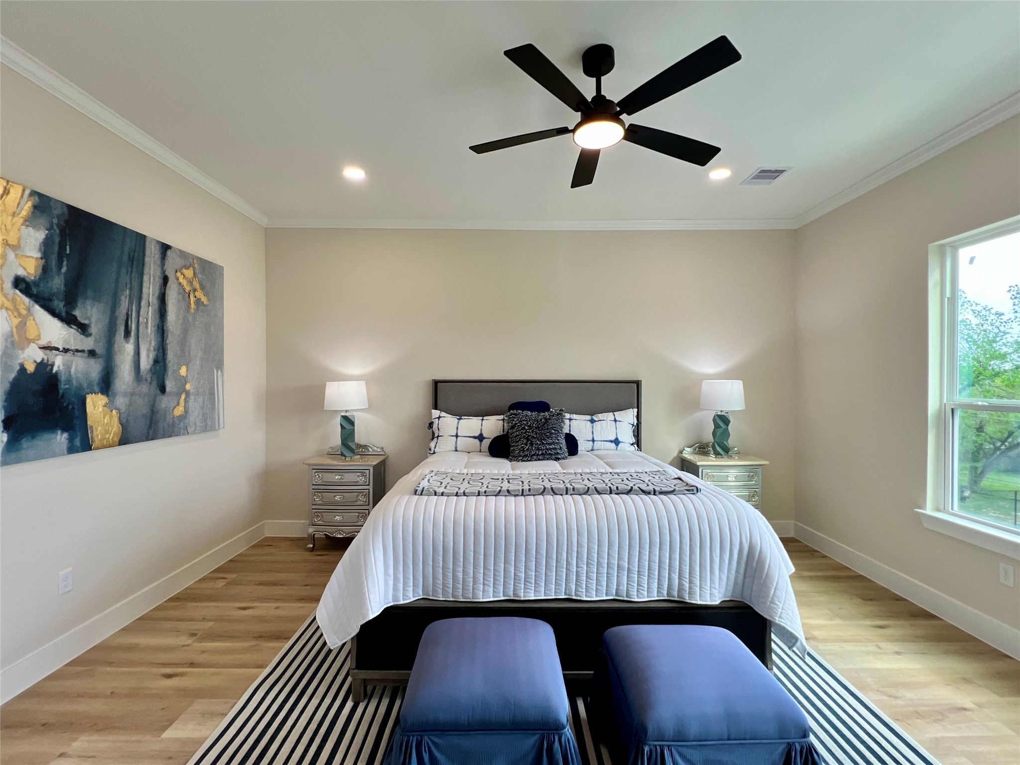 3231 Tuam Street Houston, TX 77004 - Photo 32 of 49 a bedroom with a bed a lamp and a window