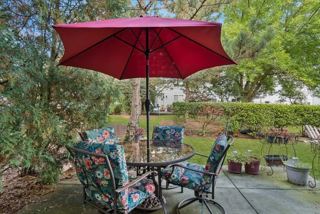 a view of an outdoor sitting area with furniture and umbrella