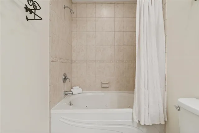 a bathroom with a bathtub and a toilet