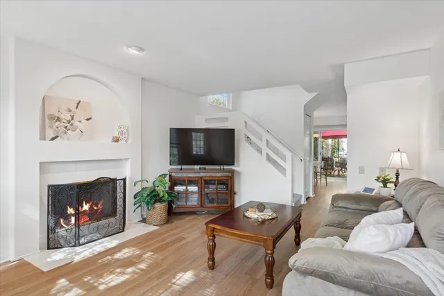 a living room with furniture a fireplace and a flat screen tv