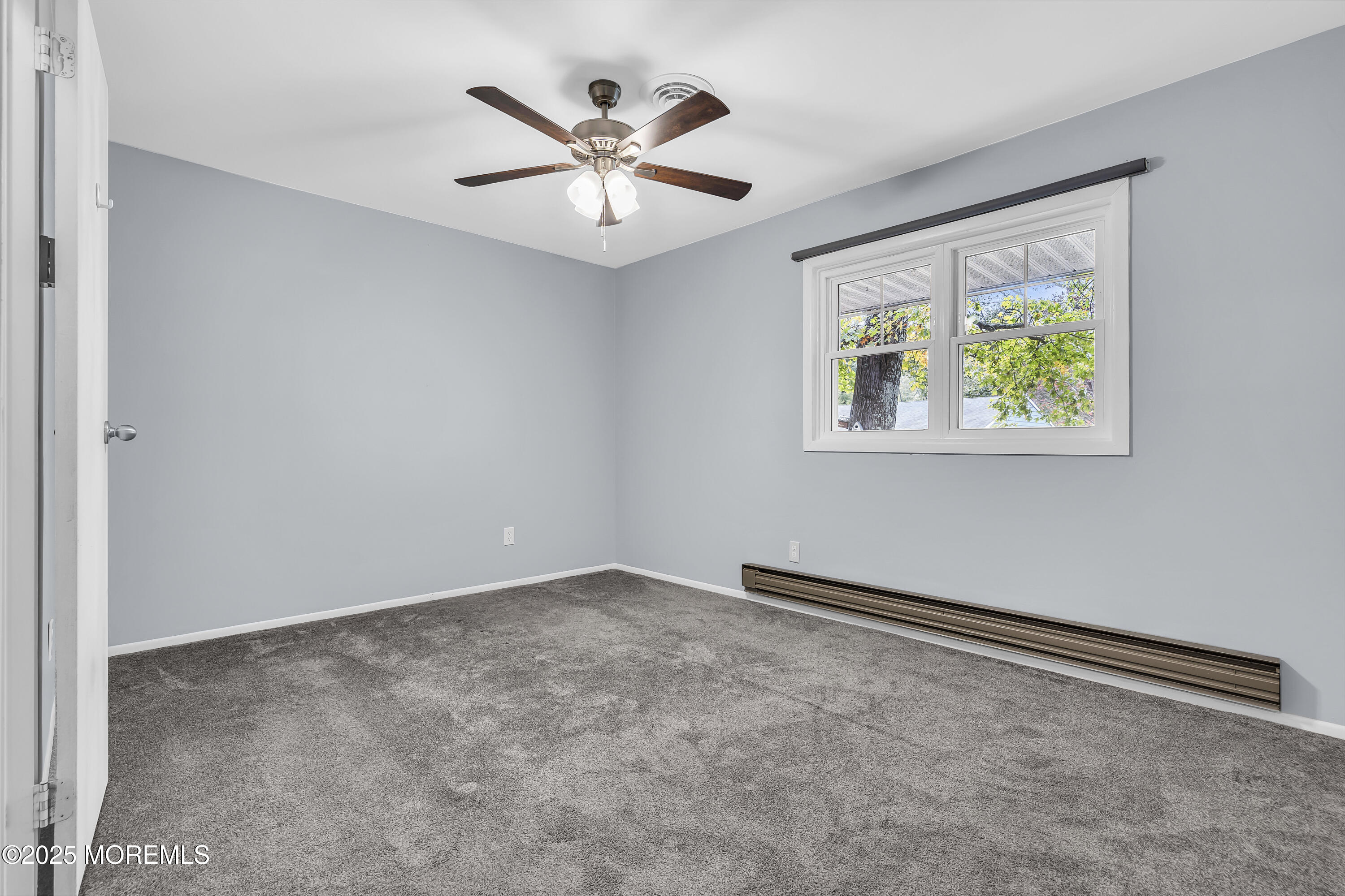 7 B Roosevelt City Road, Unit B Whiting, NJ 08759 - Photo 12 of 48 an empty room with windows and ceiling fan