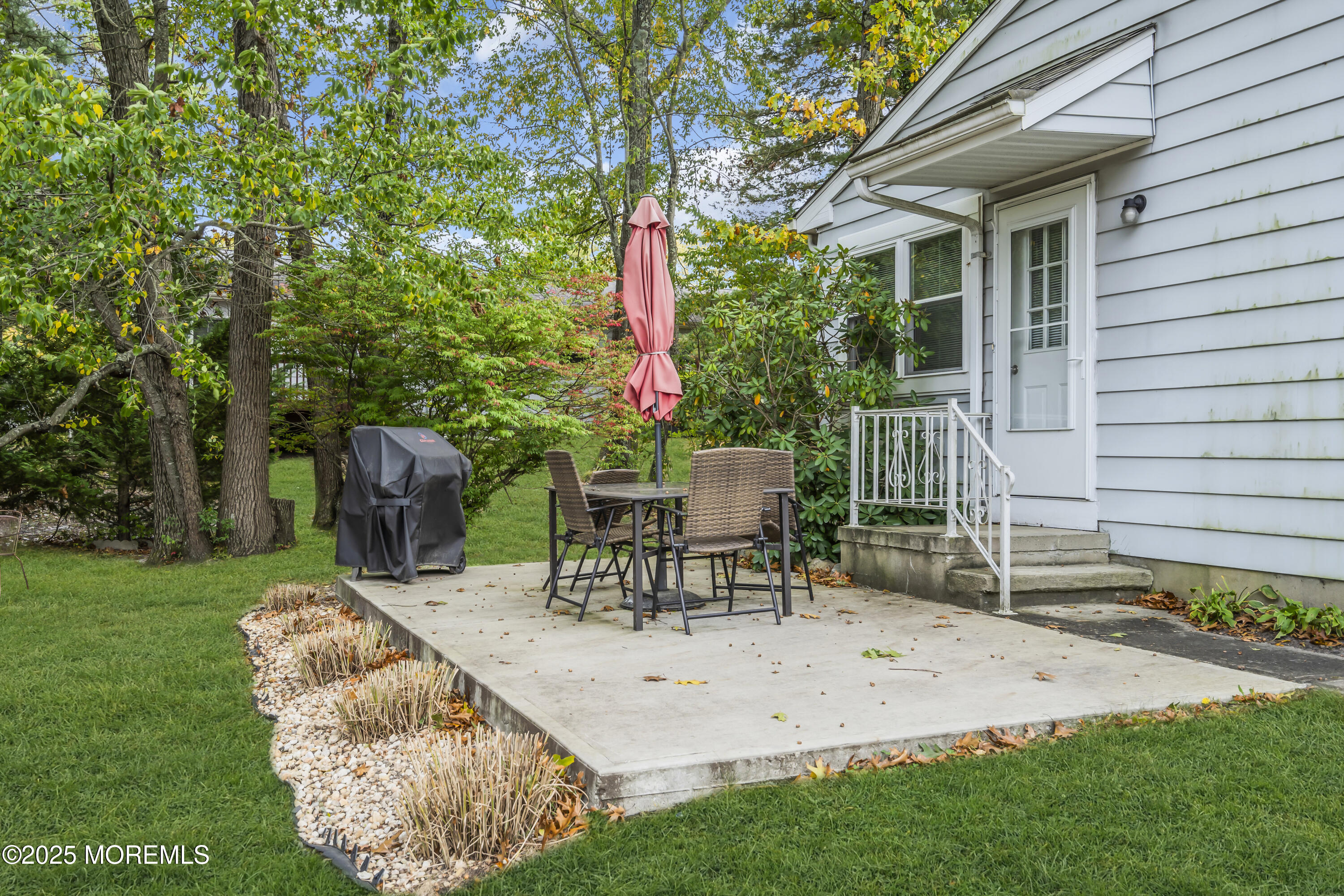 7 B Roosevelt City Road, Unit B Whiting, NJ 08759 - Photo 16 of 48 a view of a chair and table in backyard of the house