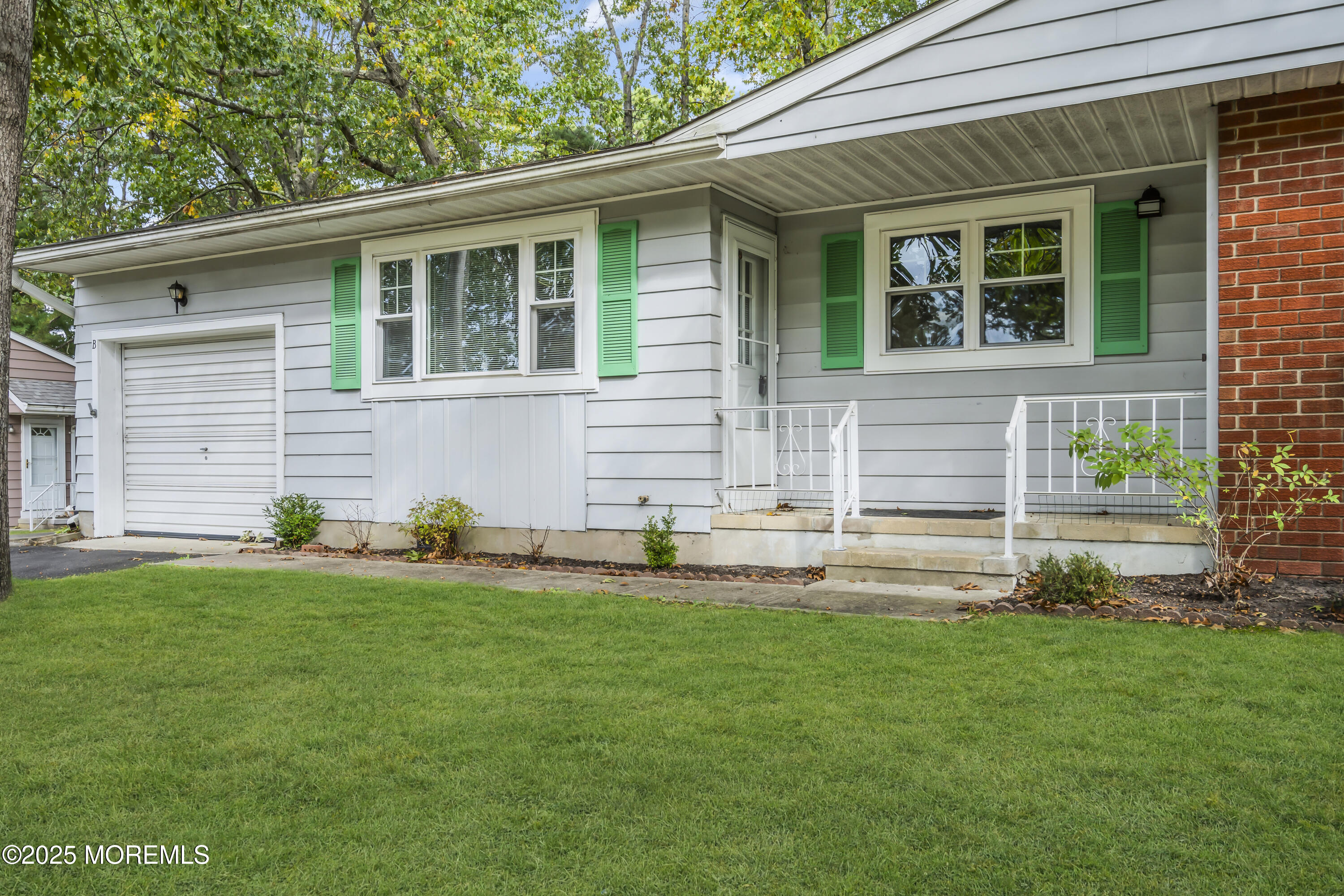 7 B Roosevelt City Road, Unit B Whiting, NJ 08759 - Photo 2 of 48 a front view of a house with a yard and sitting area